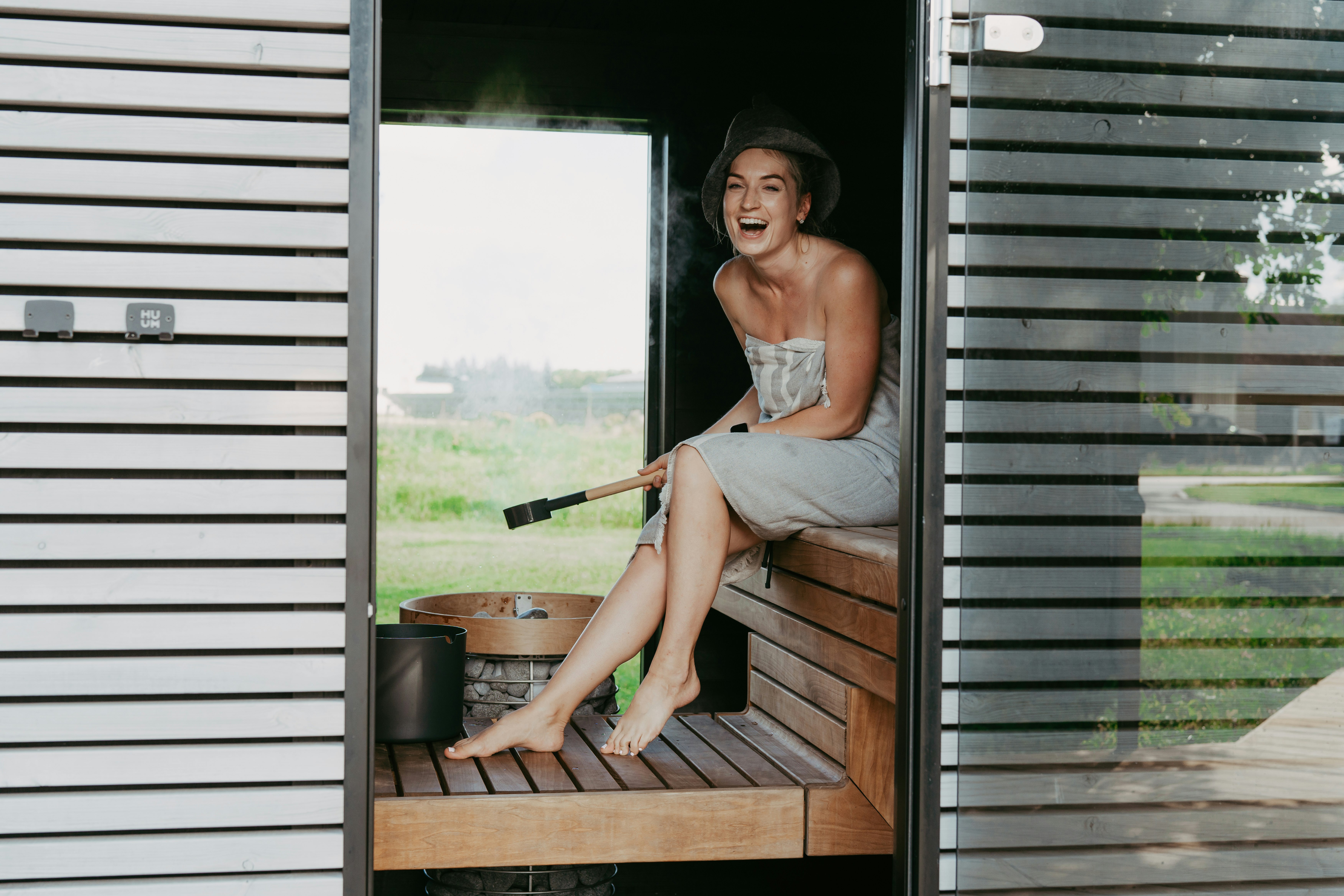 Woman laughing in a wooden sauna